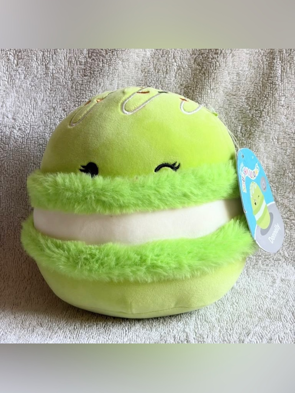 Squishmallow Green Macaron plush toy with white filling and fuzzy green edges
